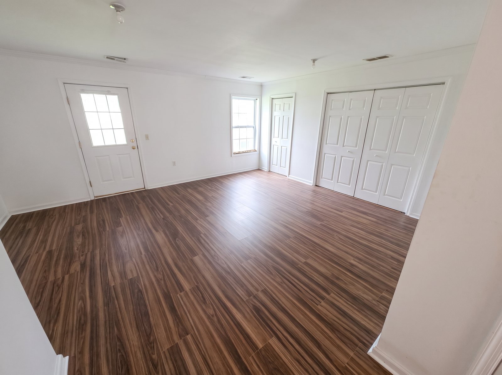 After: the same room with new wood-look LVP flooring