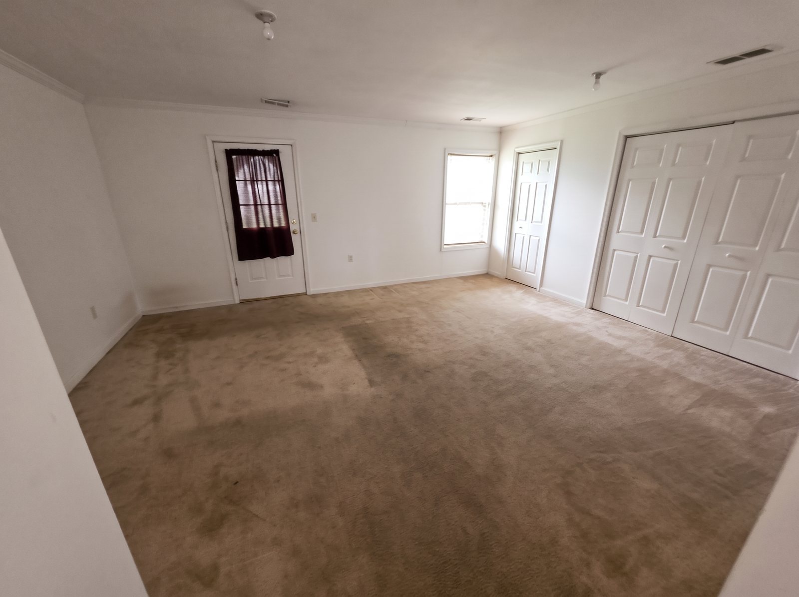 Before: room with old stained carpet