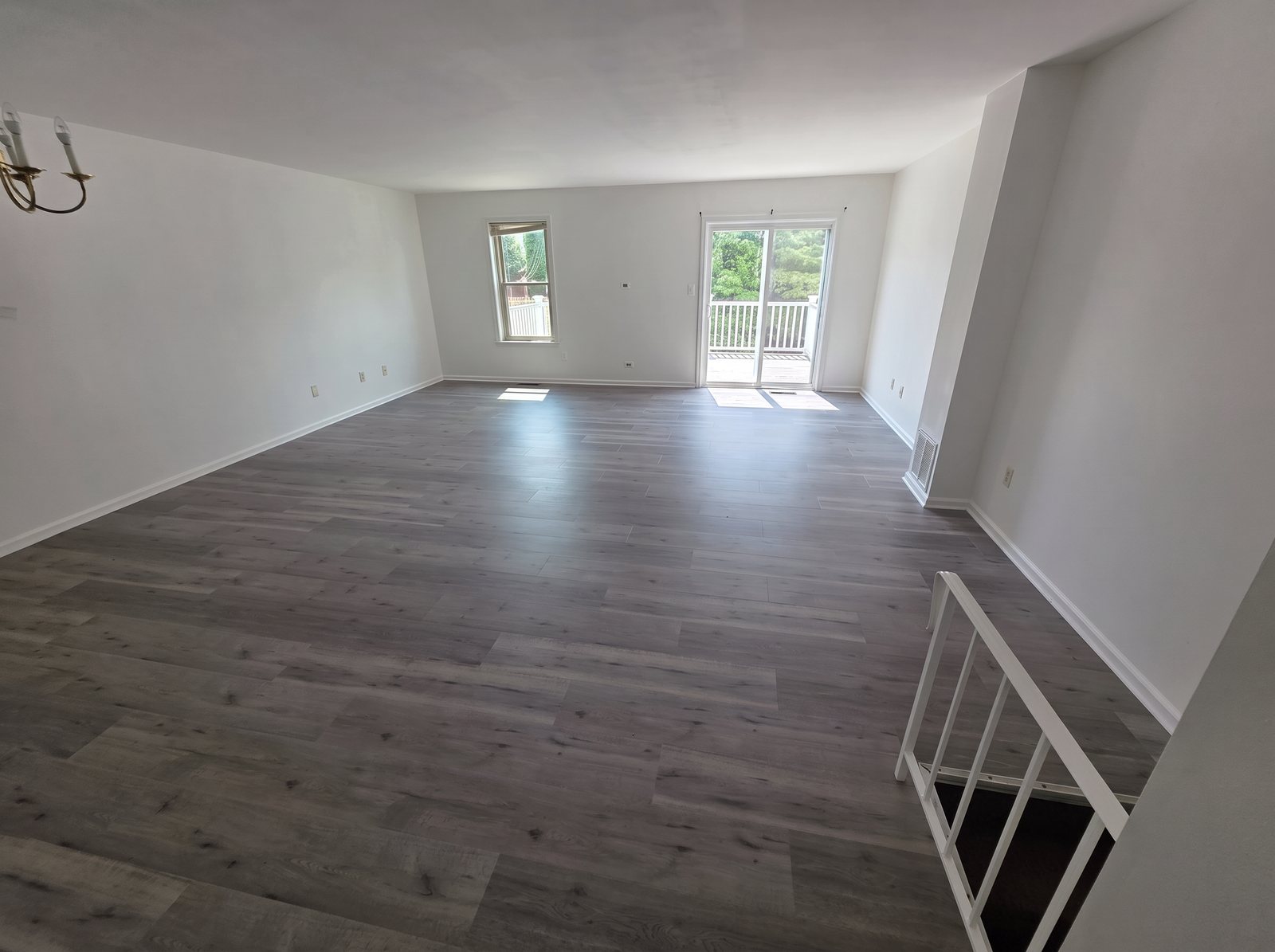 Open living room with new gray luxury vinyl plank flooring