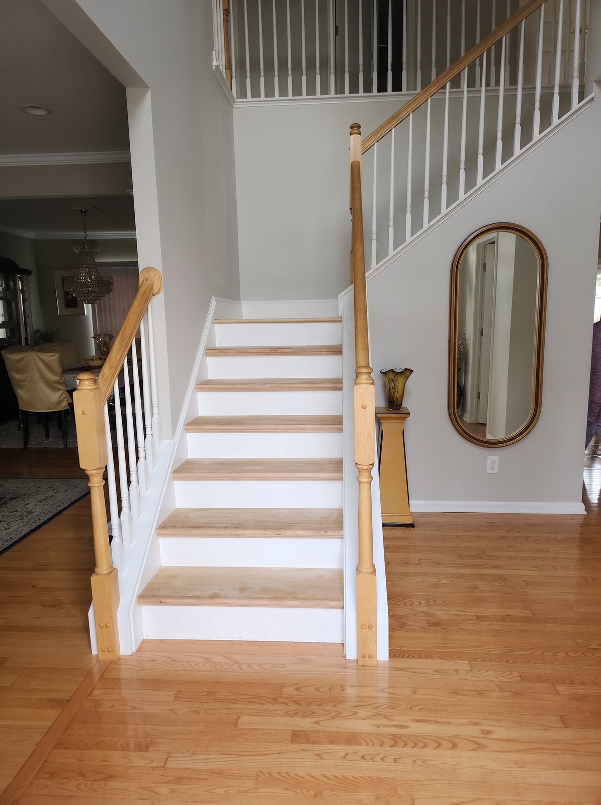 Staircase with new light wood treads, white risers and balusters