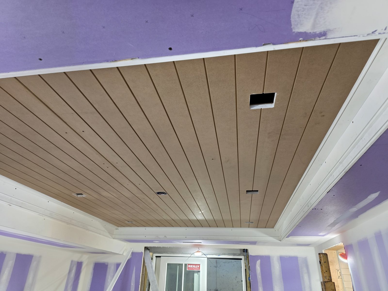 Shiplap tray ceiling during installation, boards going up