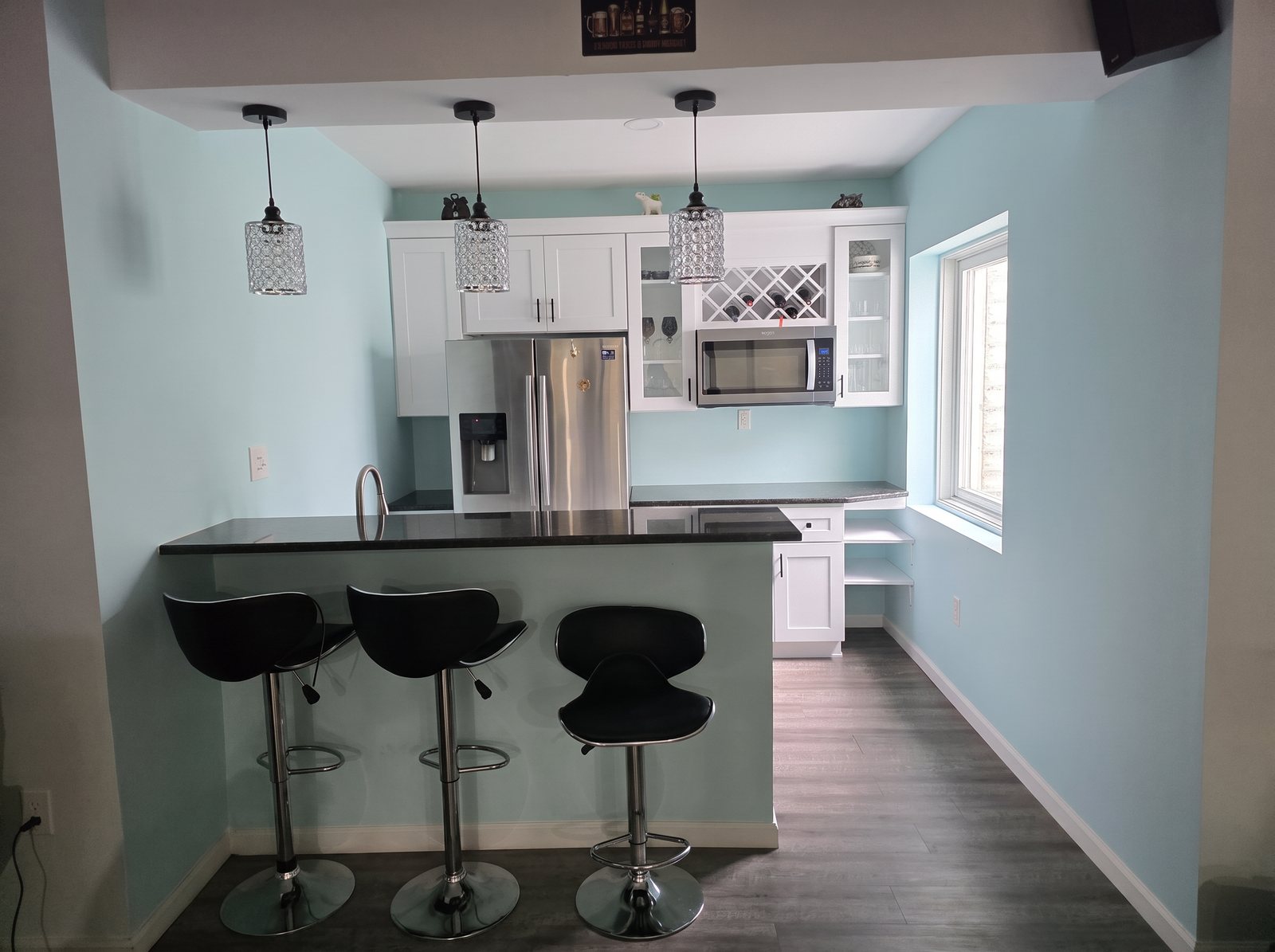 Before: basement kitchenette bar with light teal walls
